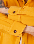 Sleeve cuff close up of Flannel Overshirt in Mustard Yellow on Jesse
