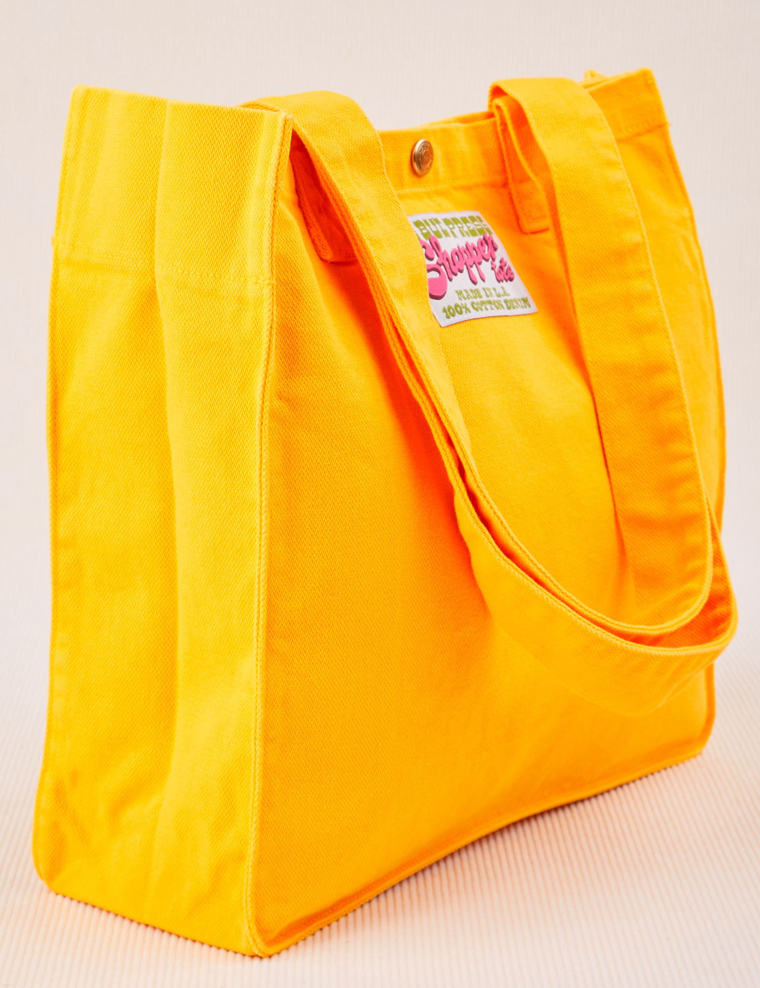 Angled view of Shopper Tote Bag in Sunshine Yellow