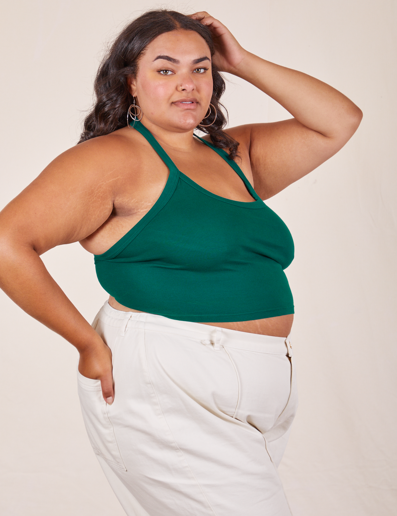 Side view of Halter Top in Hunter Green and vintage off-white Western Pants worn by Alicia