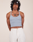Jerrod is 6'3" and wearing XS Halter Top in Periwinkle paired with vintage off-white Western Pants