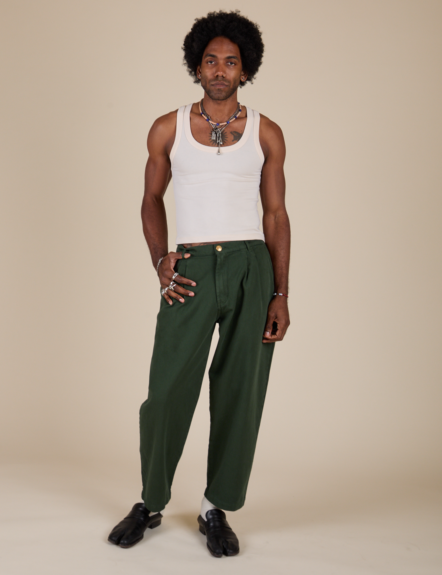 Jerrod is 6&#39;3&quot; and wearing M Heavyweight Trousers in Swamp Green paired with Tank Top in Vintage Tee Off-White