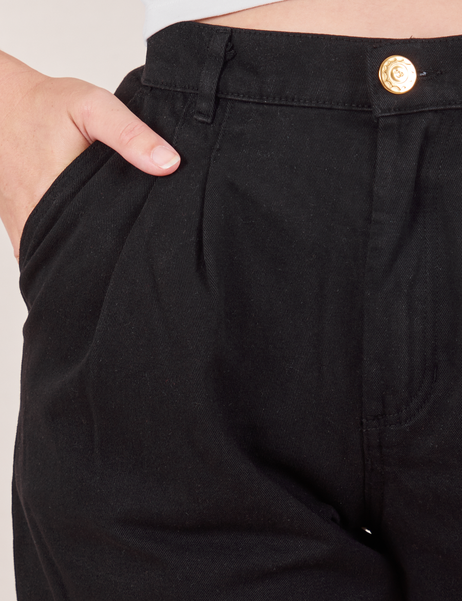 Front close up of Heavyweight Trousers in Basic Black. Alex has her hand in the pocket.