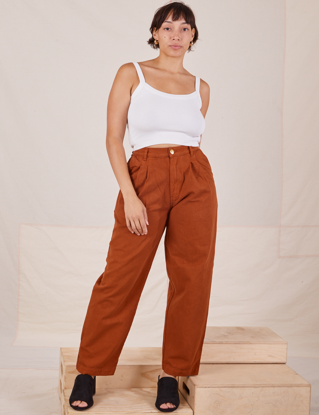 Tiara is 5'4" and wearing S Heavyweight Trousers in Burnt Terracotta paired with vintage off-white Cropped Cami