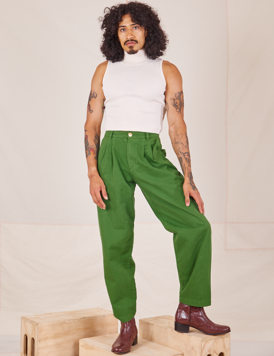 Jesse is 5'8" and wearing XXS Heavyweight Trousers in Lawn Green paired with vintage off-white Sleeveless Turtleneck