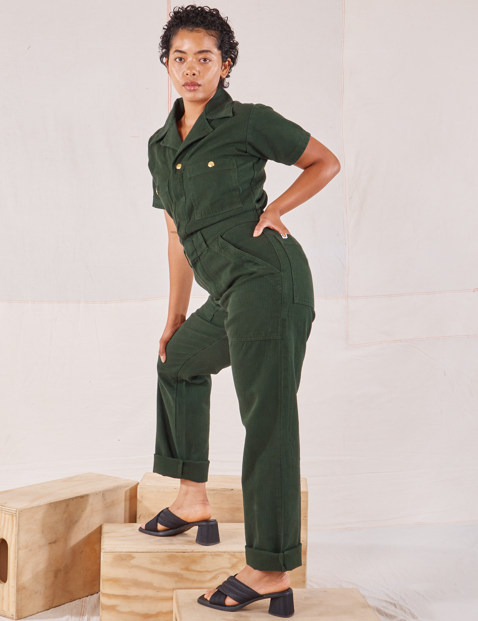 Heritage Short Sleeve Jumpsuit in Swamp Green side view on Mika