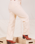 Heritage Short Sleeve Jumpsuit in Vintage Off-White side view close up of pant legs. Worn by Tiara with hand in back pocket.