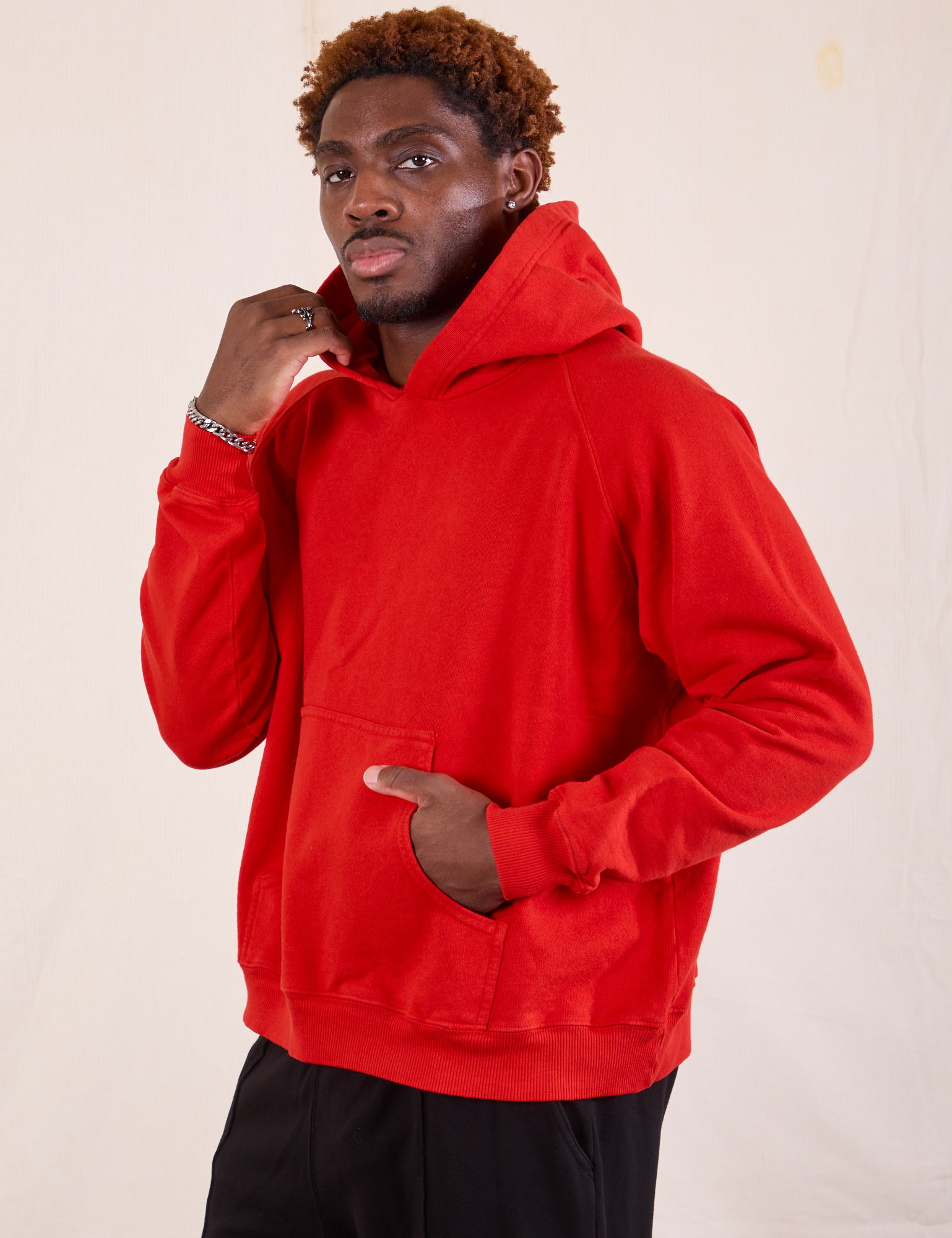 Oversized Hoodie in Mustang Red angled front view on Issac