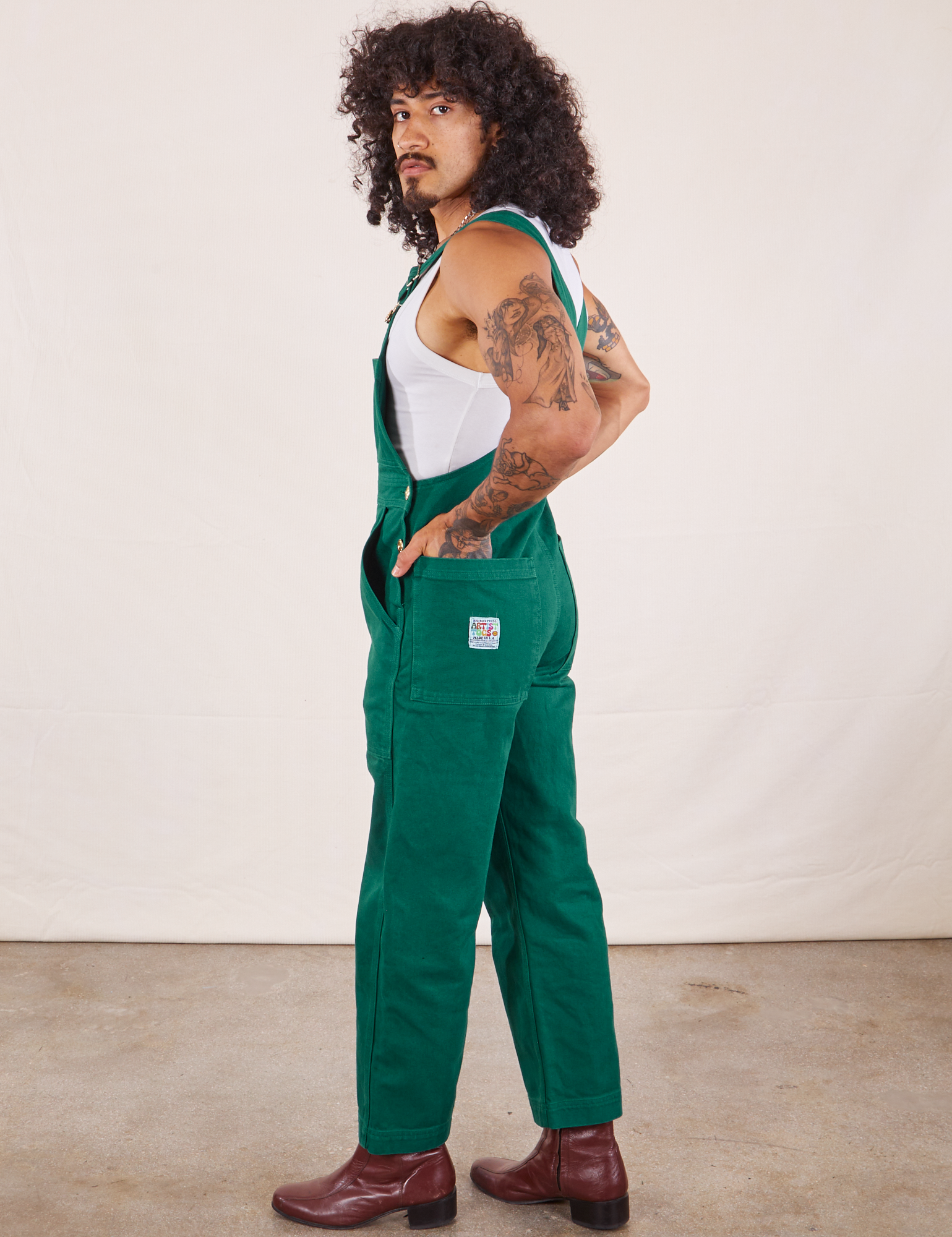 Side view of Original Overalls in Mono Hunter Green worn by Jesse