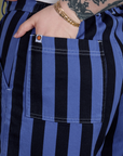 Close up of Sydney's hand in the back pocket of Longline Work Shorts in Cornflower