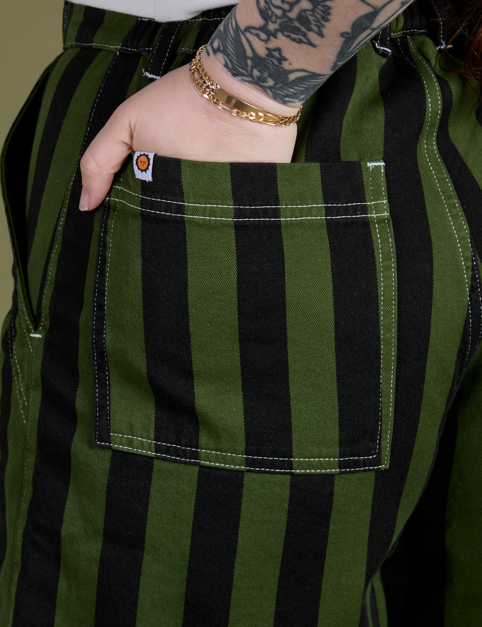 Close up of Sydney's hand in the back pocket of Longline Work Shorts in Evergreen