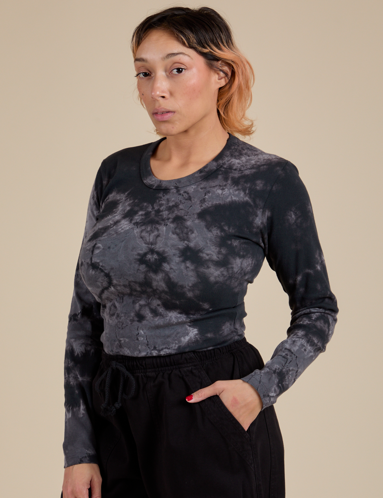 Angled front view of Long Sleeve Baby Tee in Black Magic Waters on Tiara