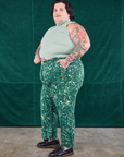 Side view of Marble Splatter Work Pants in Hunter Green and sage green Sleeveless Turtleneck on Sam