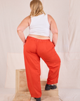 Back view of Mid-Rise Pleated Trousers in Chili Red and Cropped Tank in vintage tee off-white on Juliet