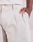 Mid-Rise Pleated Trousers in Stone White close up of Issac's hand in the front pocket