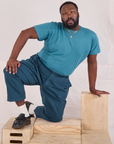 Elijah is wearing Mid-Rise Work Pants in Lagoon and marine blue Organic Vintage Tee