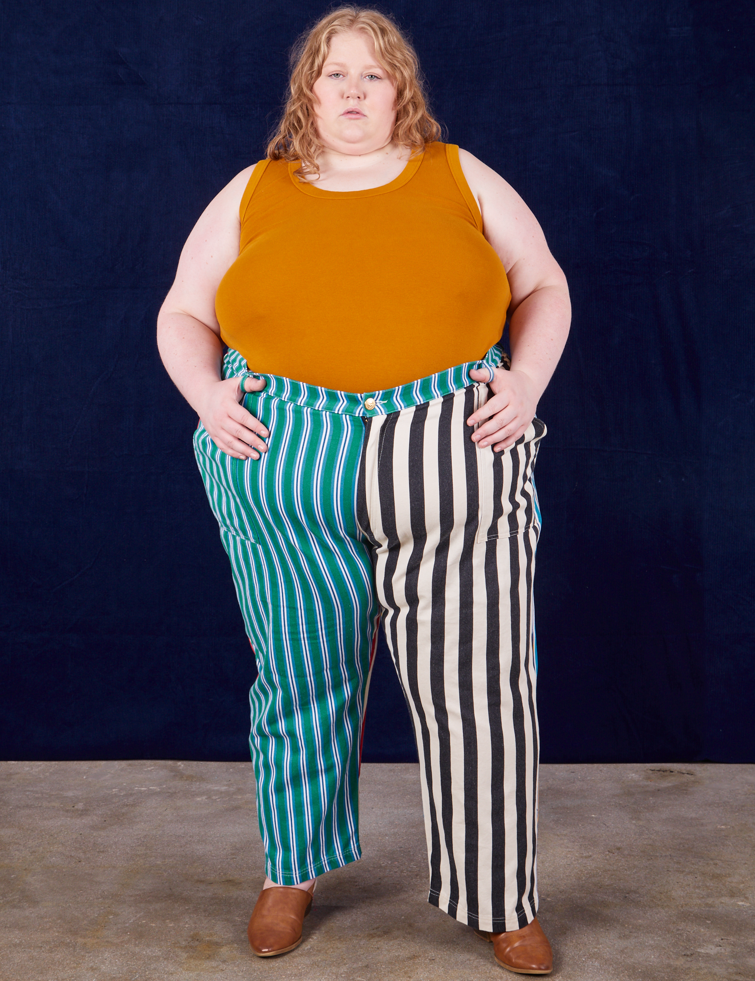 Catie is 5&#39;10&quot; and wearing 5XL 4-Way Stripe Work Pants paired with spicy mustard Tank Top