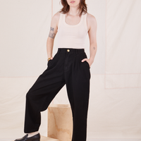 Hana is 5'3" and wearing XXS Petite Organic Trousers in Basic Black paired with vintage off-white Tank Top