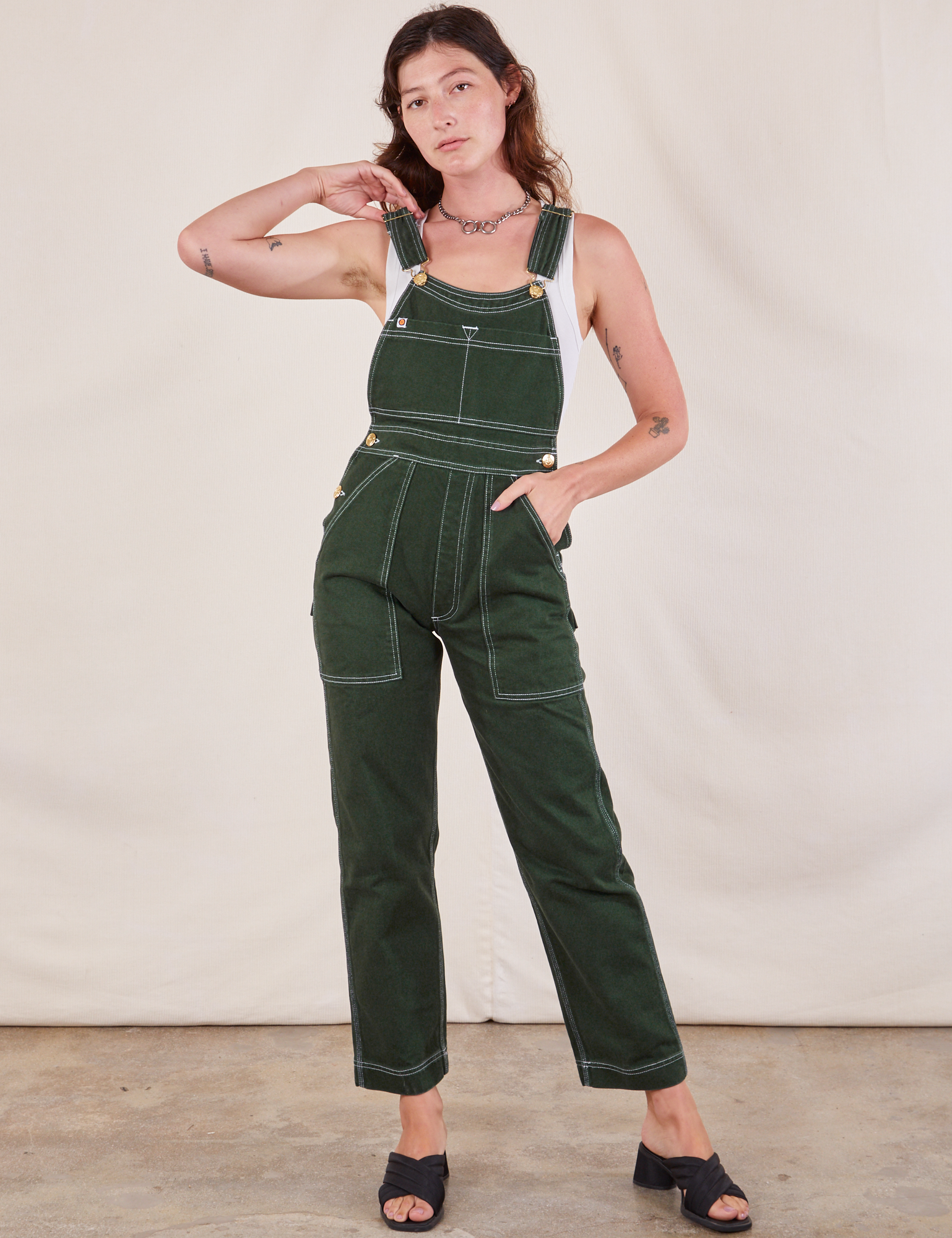 Alex is wearing Original Overalls in Swamp Green