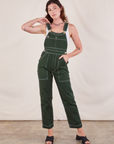 Alex is wearing Original Overalls in Swamp Green