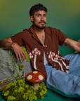 Jesse is wearing Paintstamped Pantry Button-Up in Mushroom