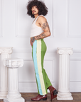 Side view of Hand-Painted Stripe Western Pants in Bright Olive and vintage off-white Tank Top worn by Jesse. Baby blue and off-white hand painted stripe down the side of the pant