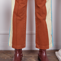 Pant leg close up of Hand-Painted Stripe Western Pants in Burnt Terracotta worn by Gabi