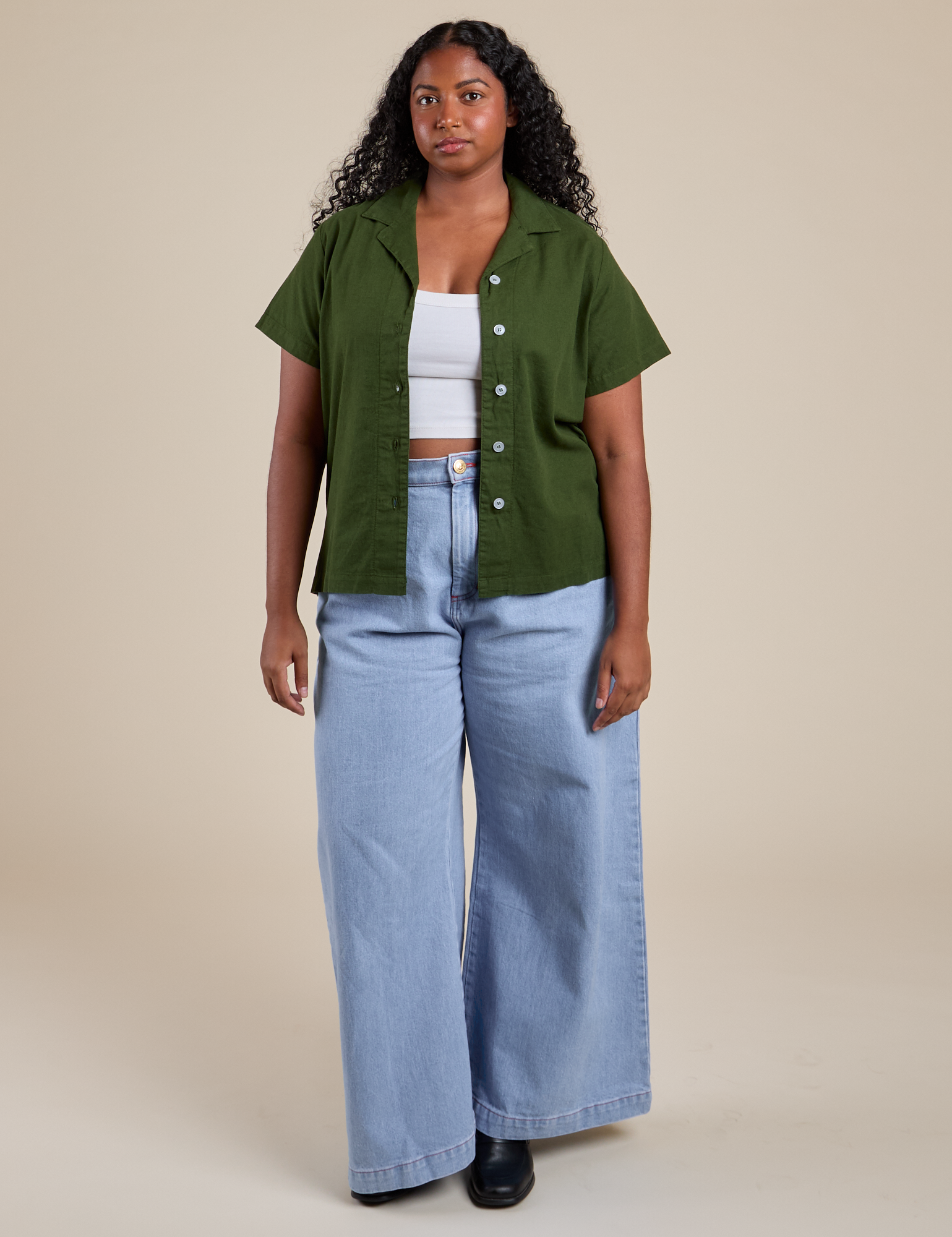 Meghna is wearing Pantry Button-Up in Evergreen and light wash Indigo Wide Leg Trousers