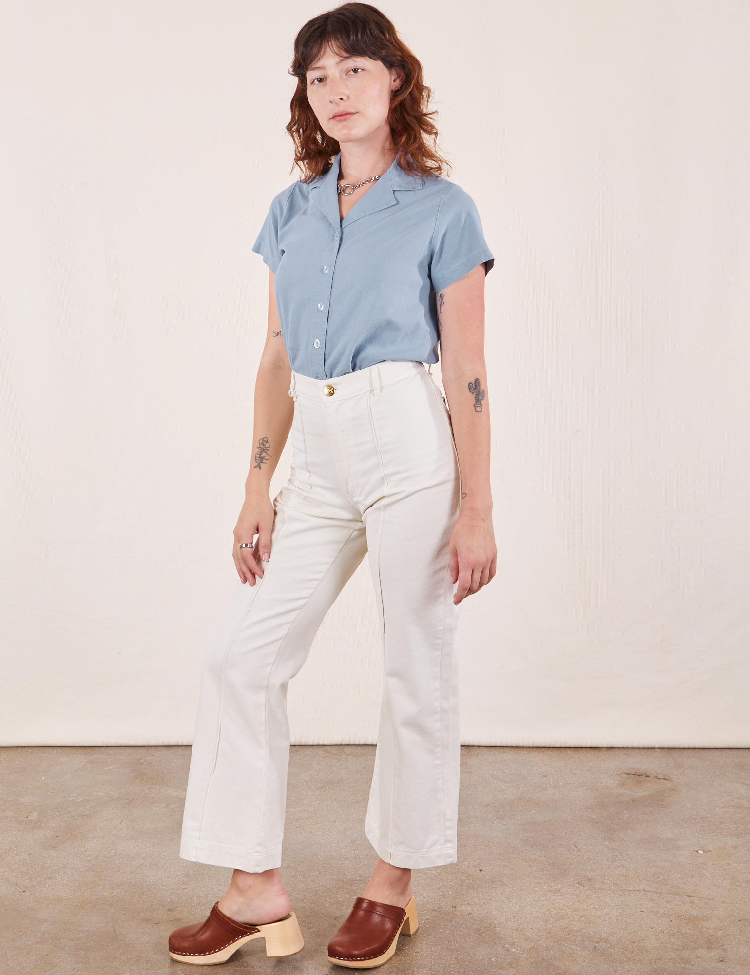 Alex is wearing Pantry Button-Up in Periwinkle tucked into vintage off-white Western Pants