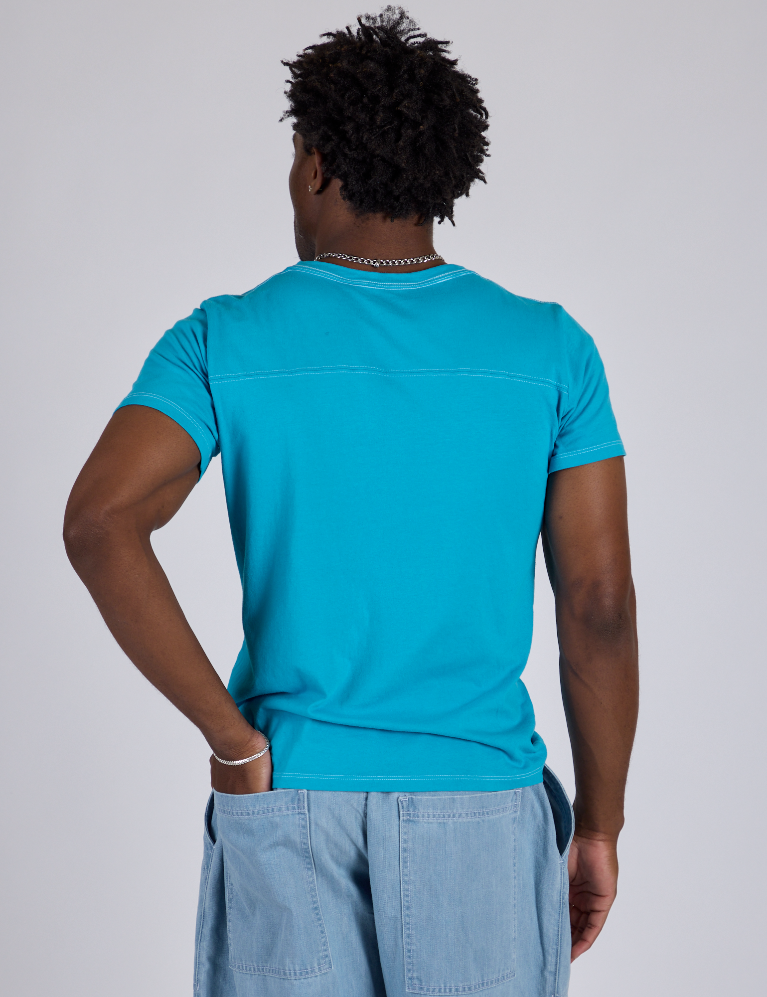 Jr. Varsity Tee in Hawaiian Blue back view on Isaac