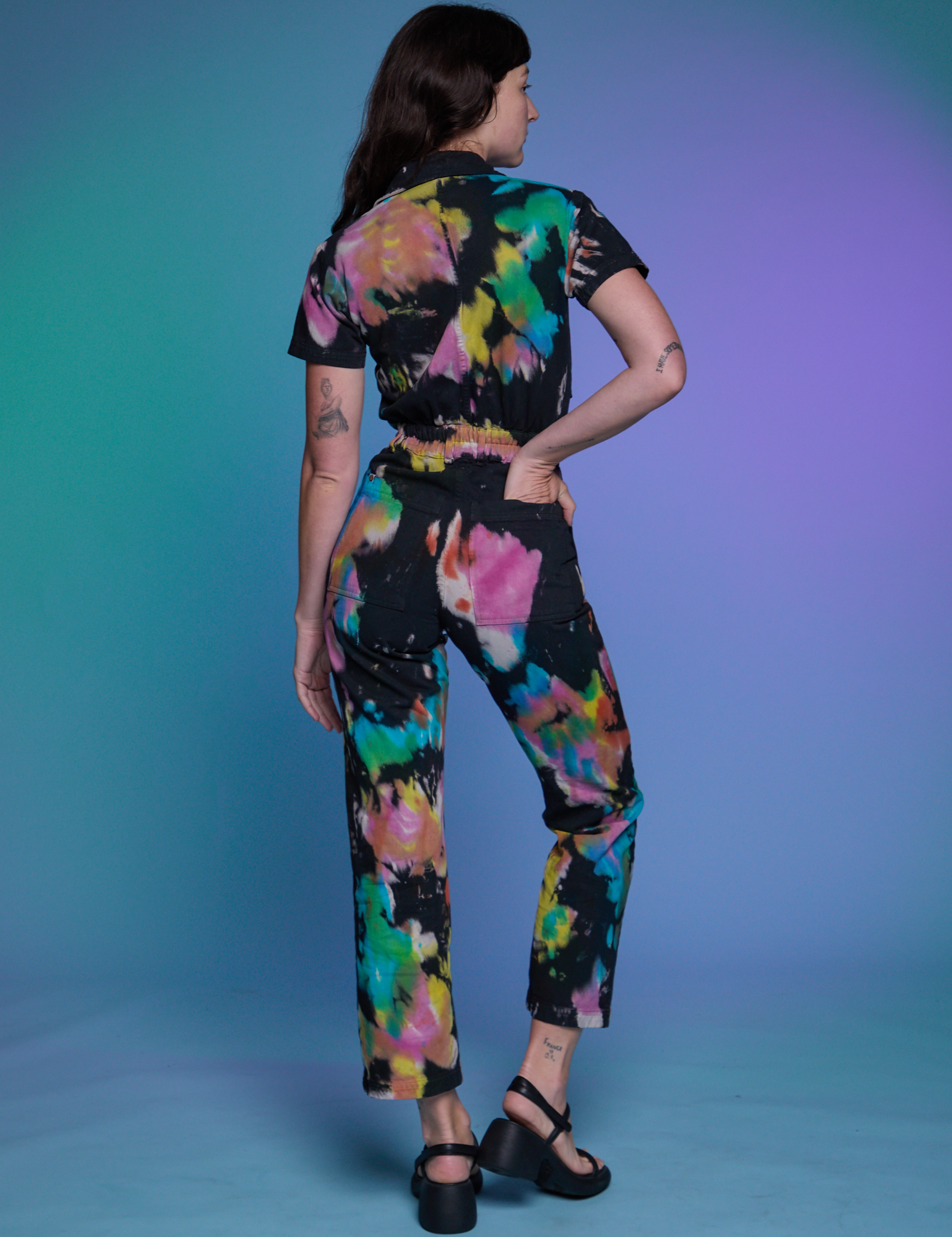 Short Sleeve Jumpsuit in Rainbow Magic Waters back view on Alex