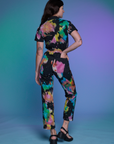 Short Sleeve Jumpsuit in Rainbow Magic Waters back view on Alex