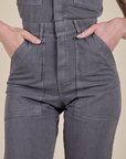 Short Sleeve Jumpsuit in Washed Grey close up with Alex's hand in the front pockets