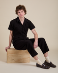 Quinn is wearing Short Sleeve Jumpsuit in Basic Black