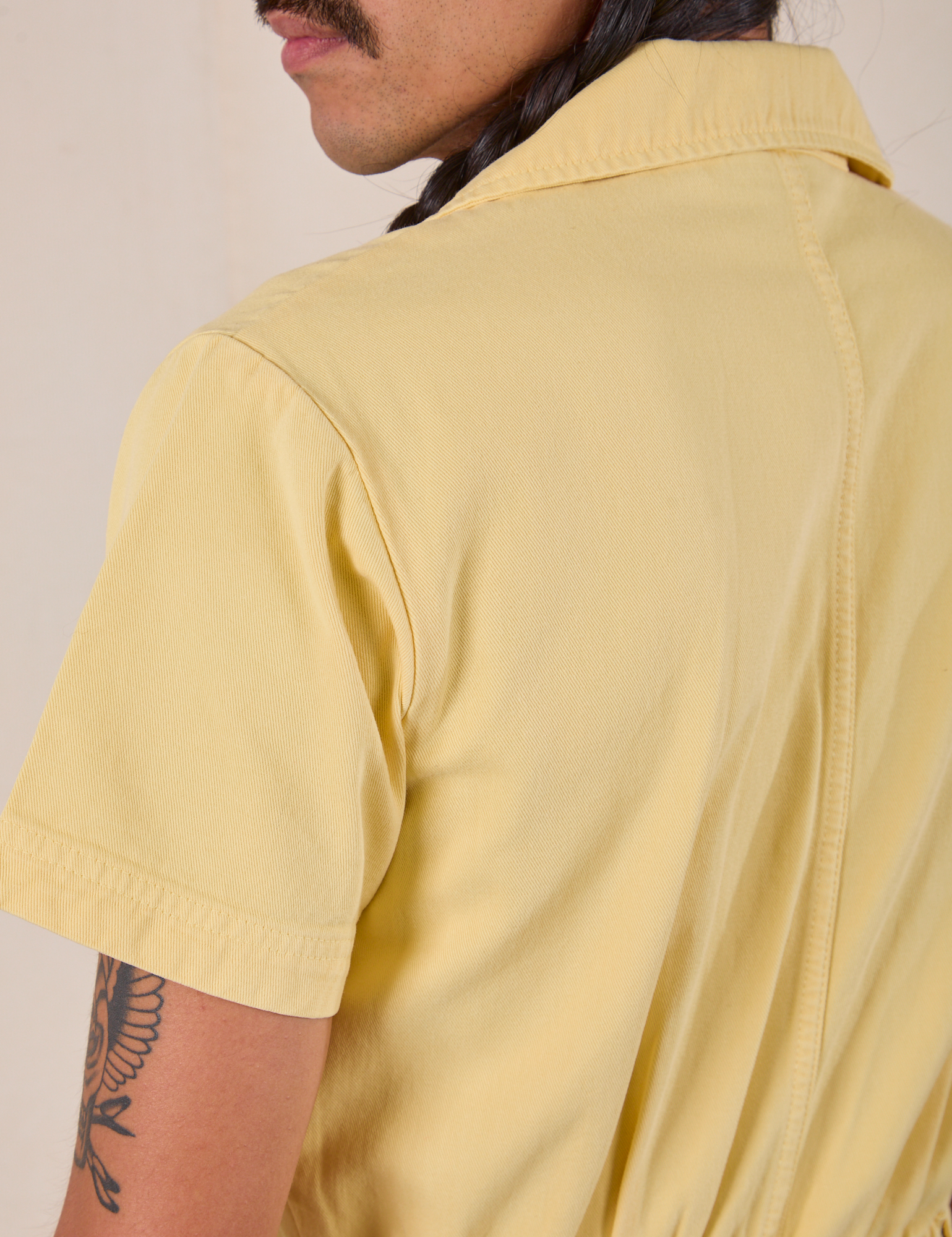 Short Sleeve Jumpsuit in Butter Yellow back shoulder close up on Anthony