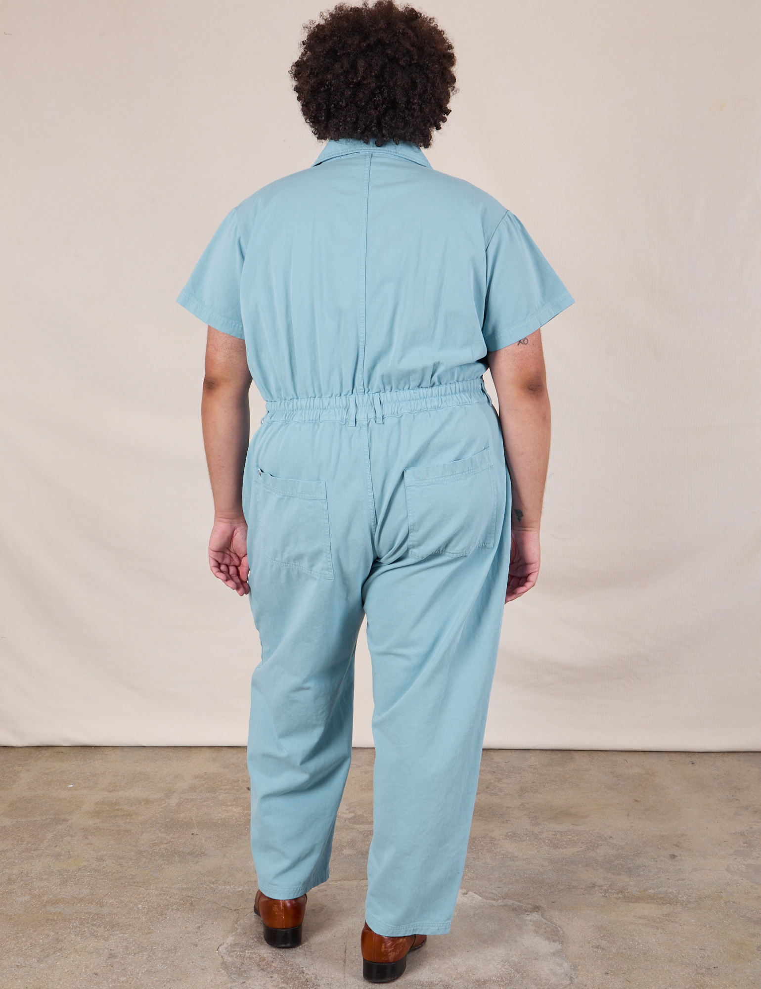 Short Sleeve Jumpsuit in Baby Blue back view on Miguel