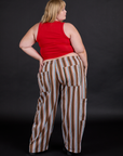 Back view of Striped Drop Pocket Pants in Retro Rainbow and mustang red Tank Top