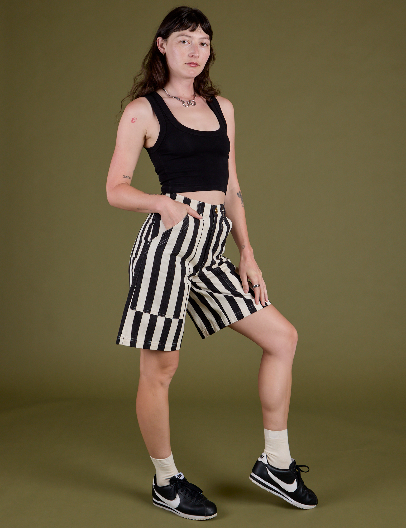 Angled front view of  Longline Work Shorts in Natural and black Cropped Tank on Alex