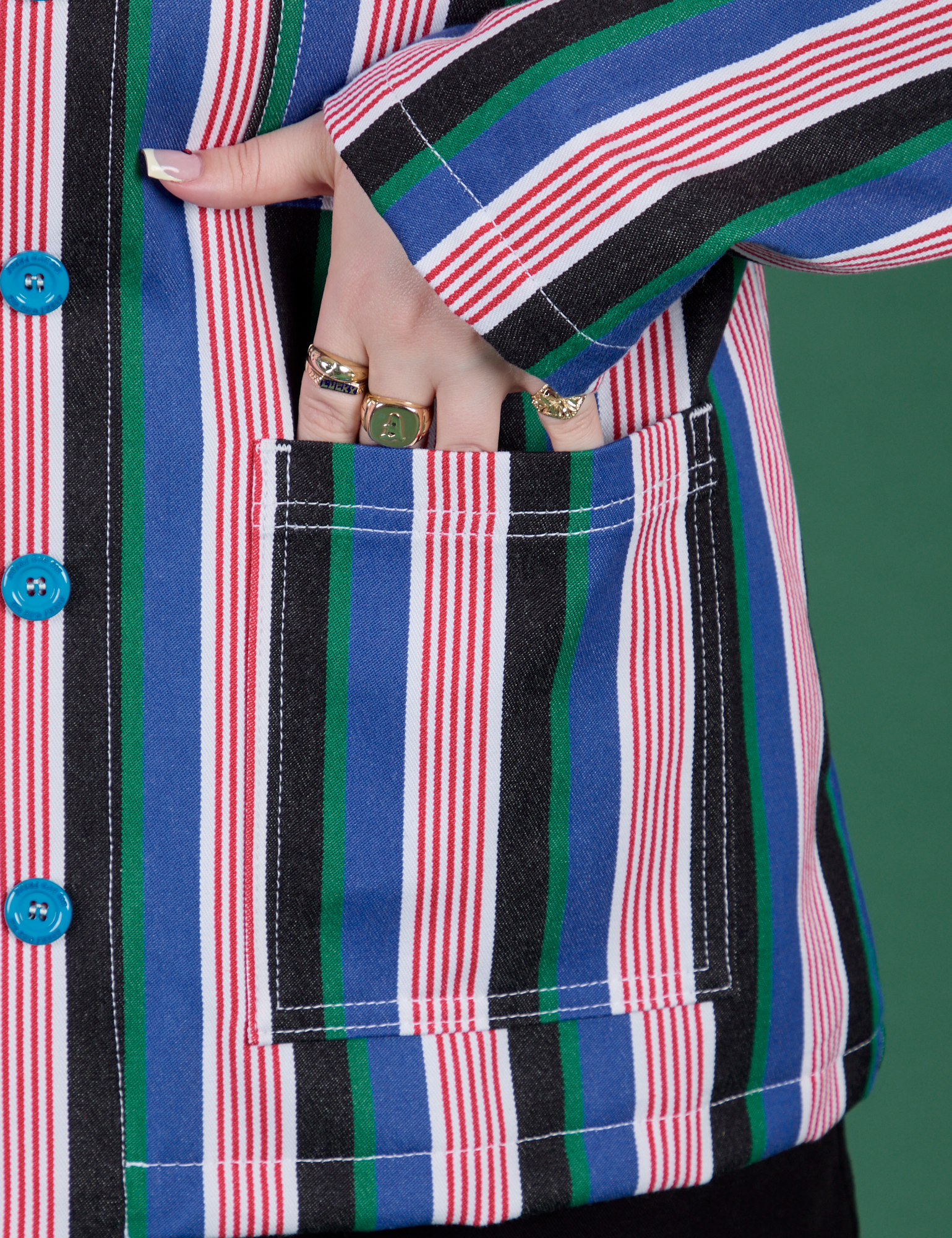 Close up of Sydney's hand in the front pocket of Stripe Work Jacket in Pacific Stripe