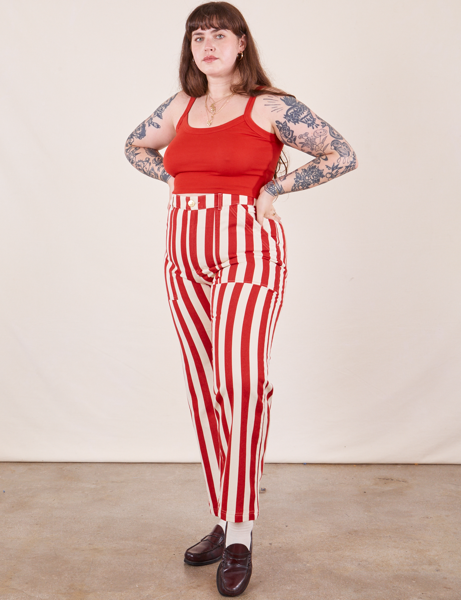 Sydney is wearing Work Pants in Cherry Stripe and mustang red Cropped Cami