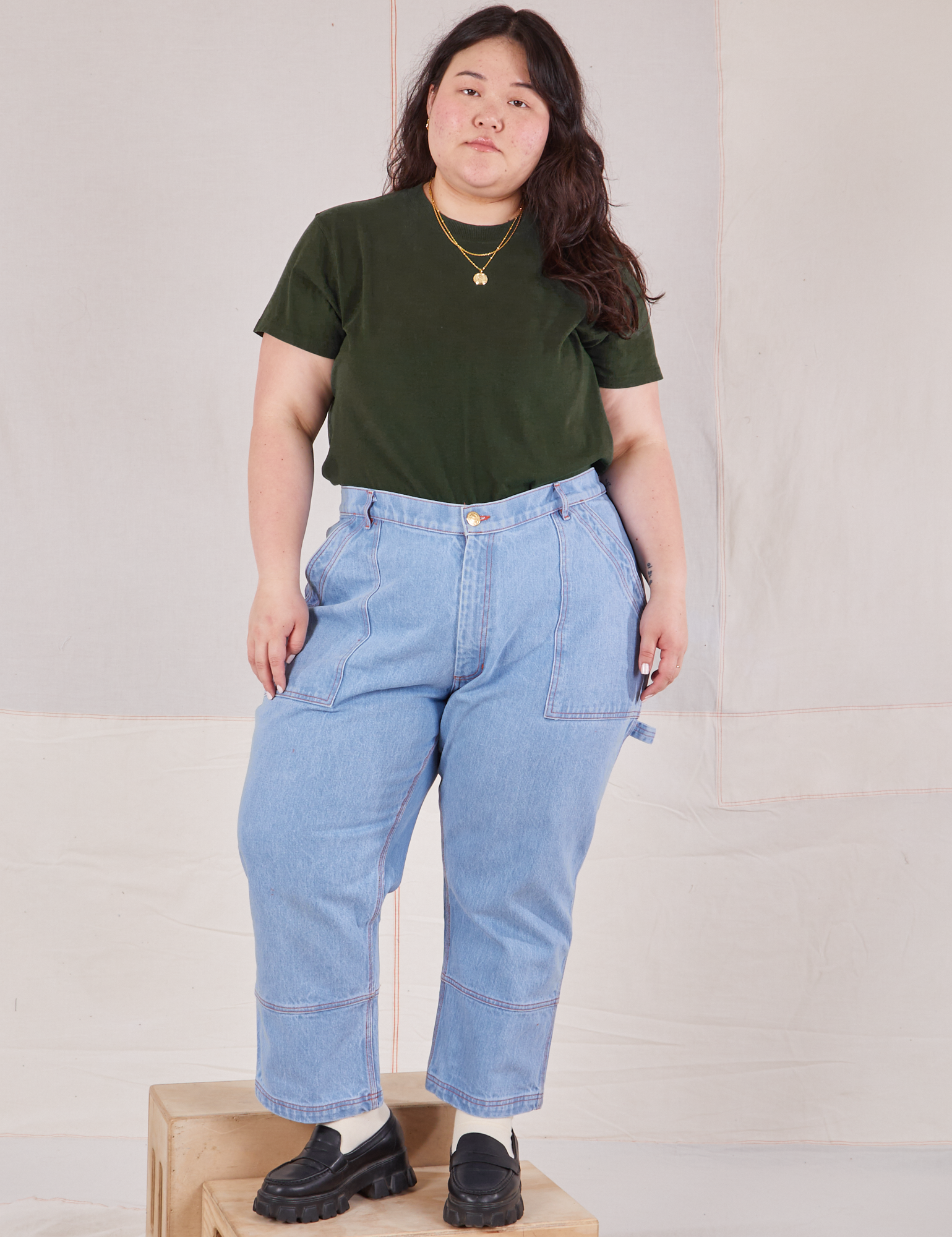 Ashley is wearing Organic Vintage Tee in Swamp Green tucked into light wash Carpenter Jeans