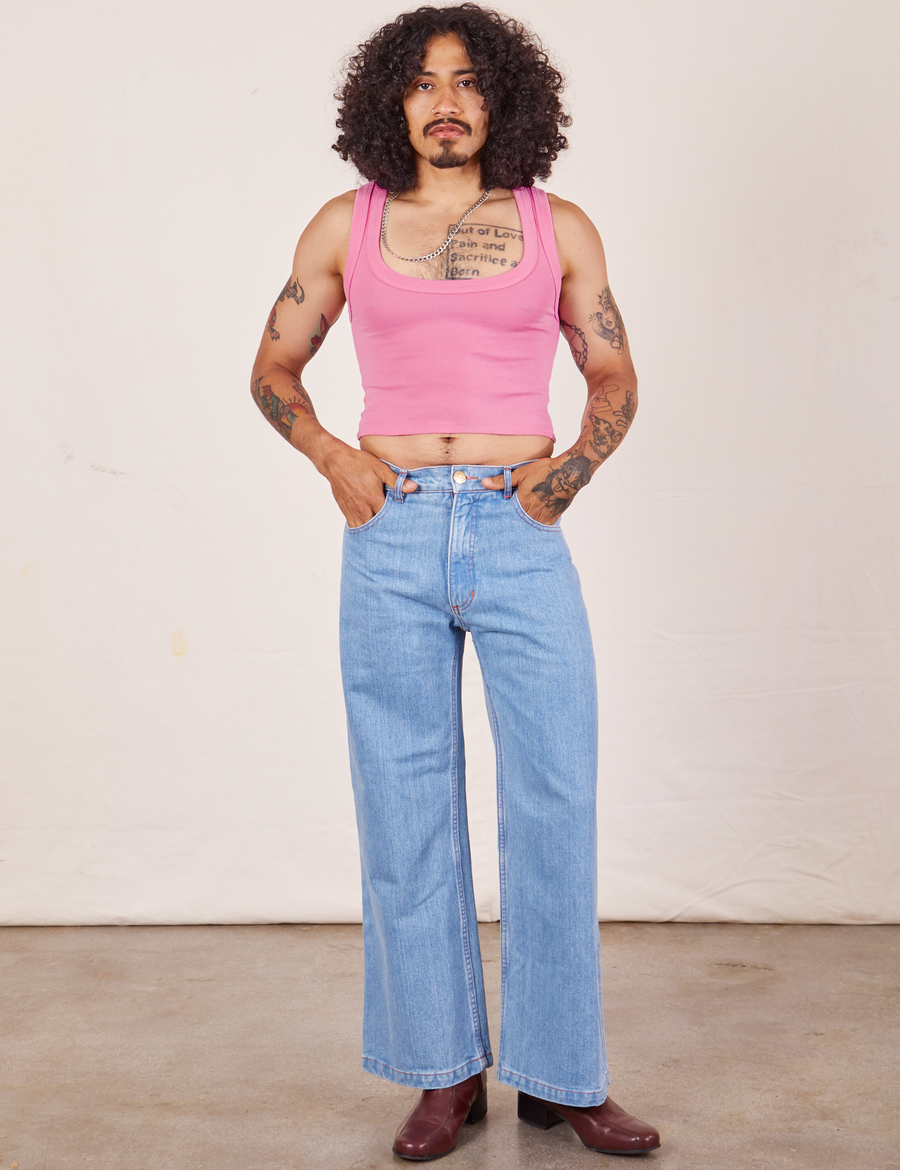 Jesse is wearing Cropped Tank Top in Bubblegum Pink paired with light wash Sailor Jeans