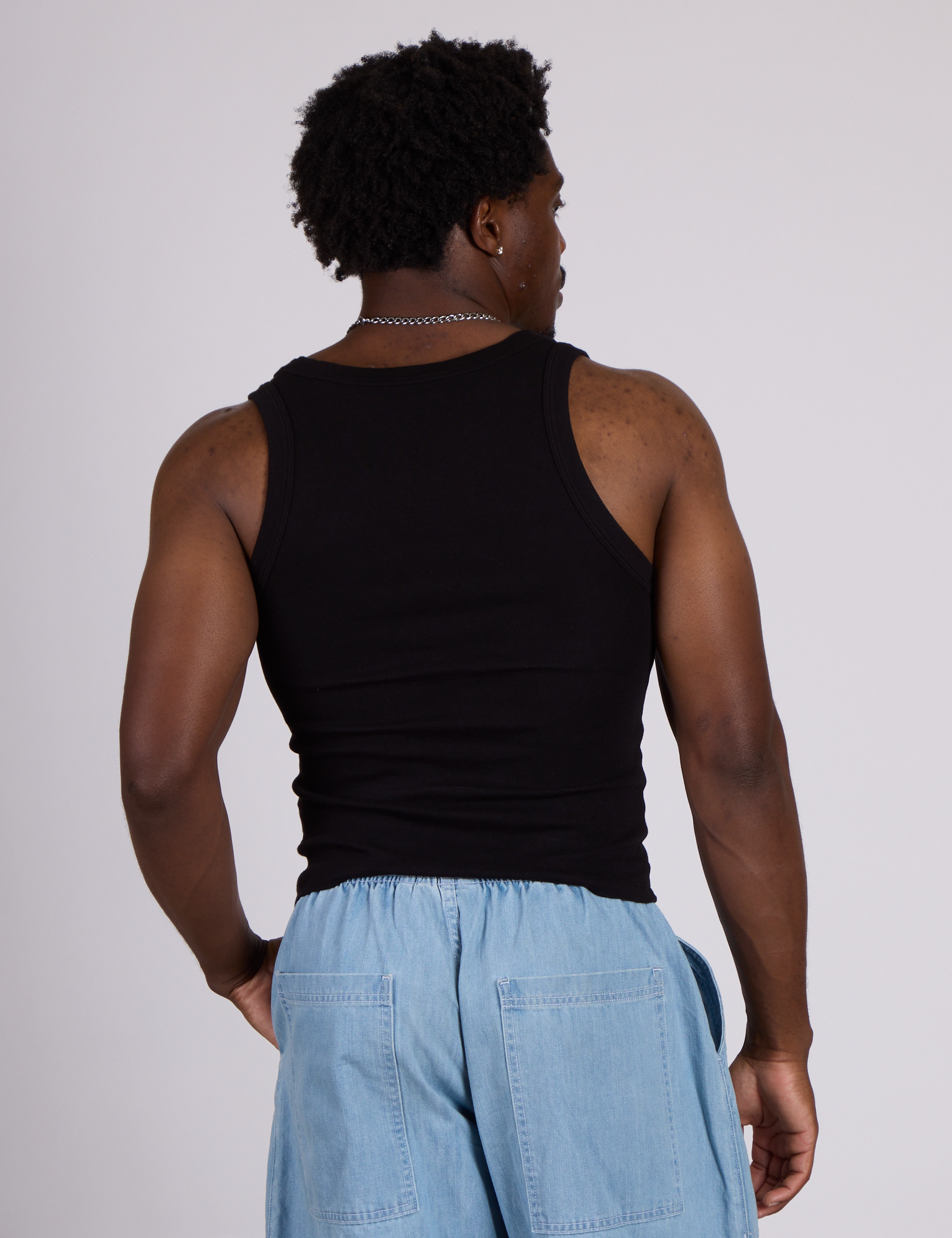 Back view of The Tank Top in Basic Black on Isaac