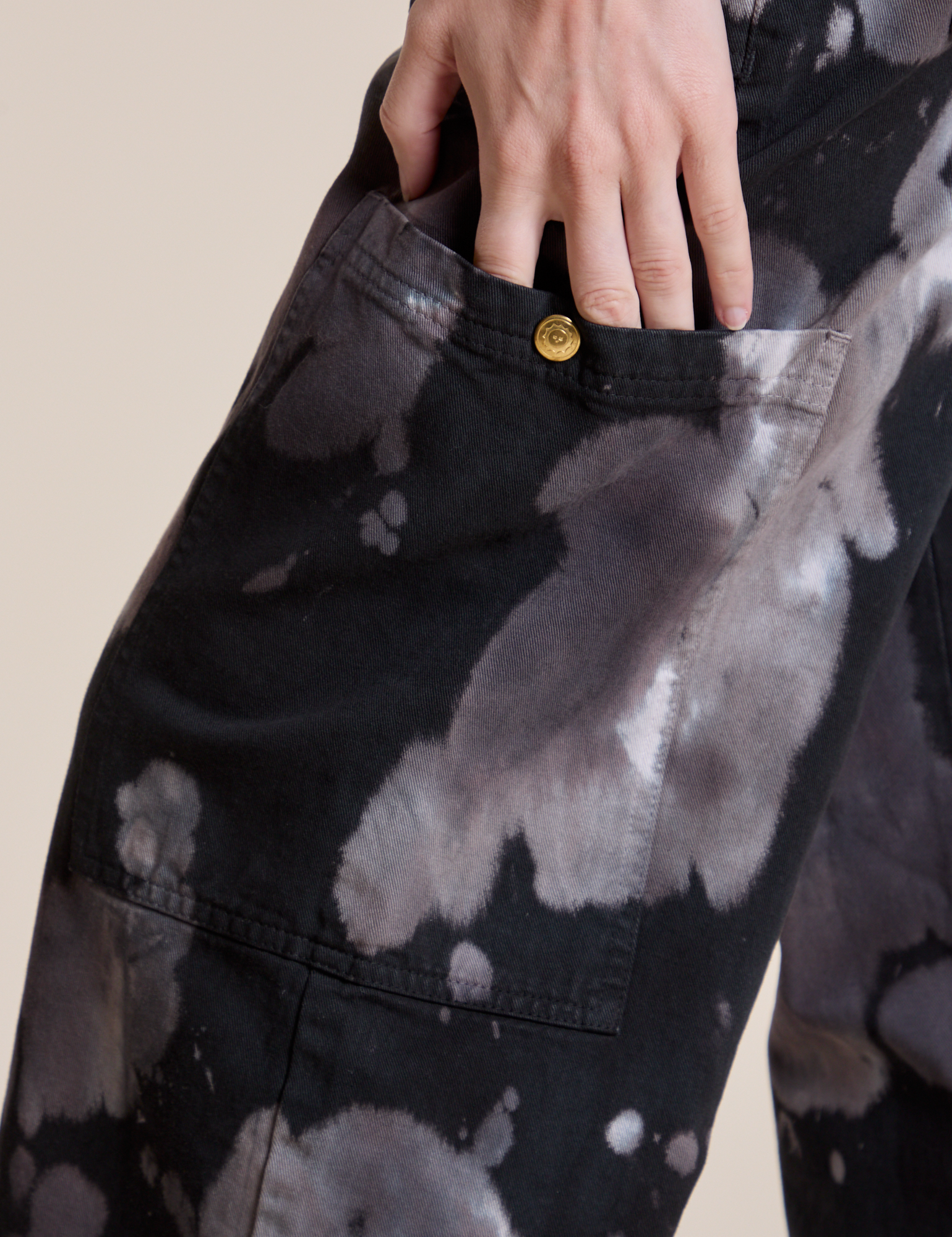 Close up of Alex's hand tucked into the side pant leg pocket of Magic Waters Drop Pocket Pants in Ink Blot
