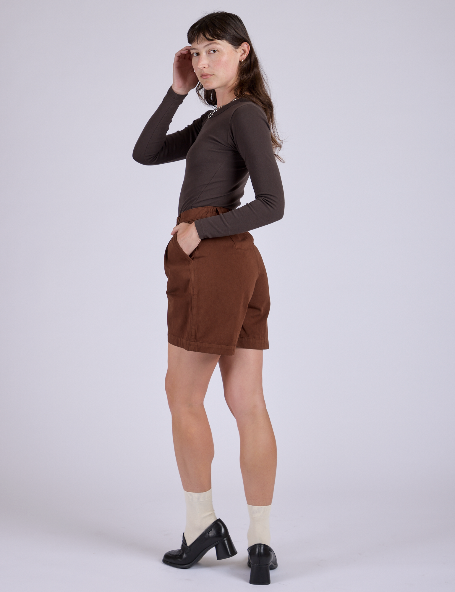 Pleated Trouser Shorts in Fudgesicle Brown angled back view on Alex