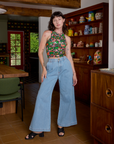 Alex is wearing Kitchen Collection Racerback Tank and light wash Indigo Wide Leg Trousers