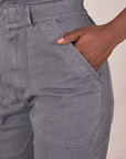 Close up of Cheyann's hand in the front pocket of Short Sleeve Jumpsuit in Washed Grey