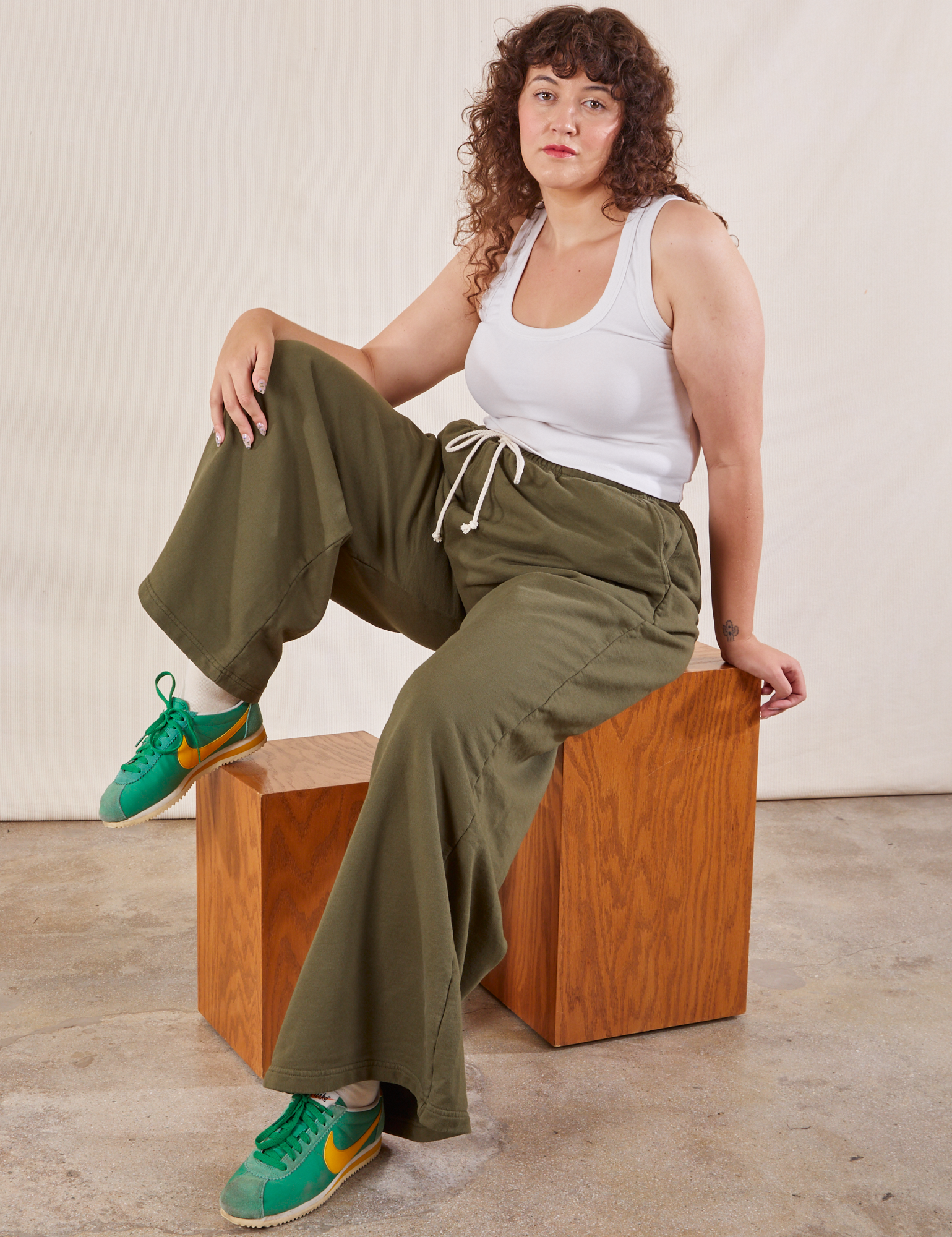 Ryan is wearing Wide Leg Sweat Pants in Surplus Green and Cropped Tank in vintage tee off-white