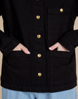 Hana has both hands in the front pocket of Work Jacket in Basic Black