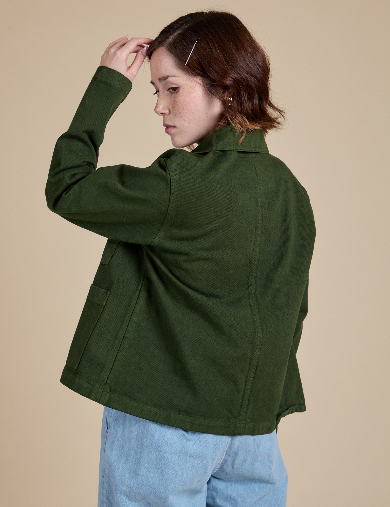 Angled back view of Denim Work Jacket in Evergreen on Hana