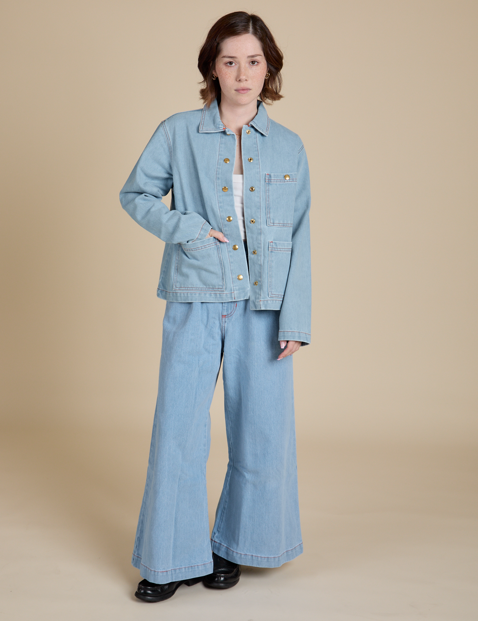 Hana is wearing Indigo Denim Work Jacket in Light Wash and light wash Indigo Wide Leg Trousers